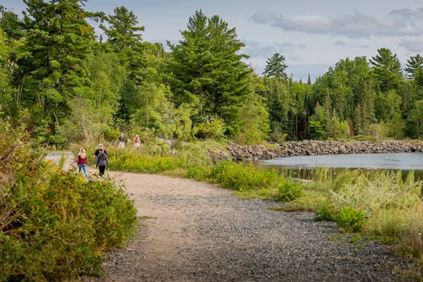 Hikers trek along the lakeside portion of the Tunnel Island Trail.