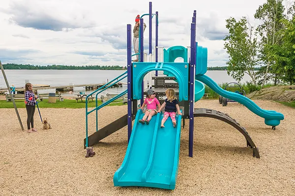 Kids on the play structure at Keewatin Beach.