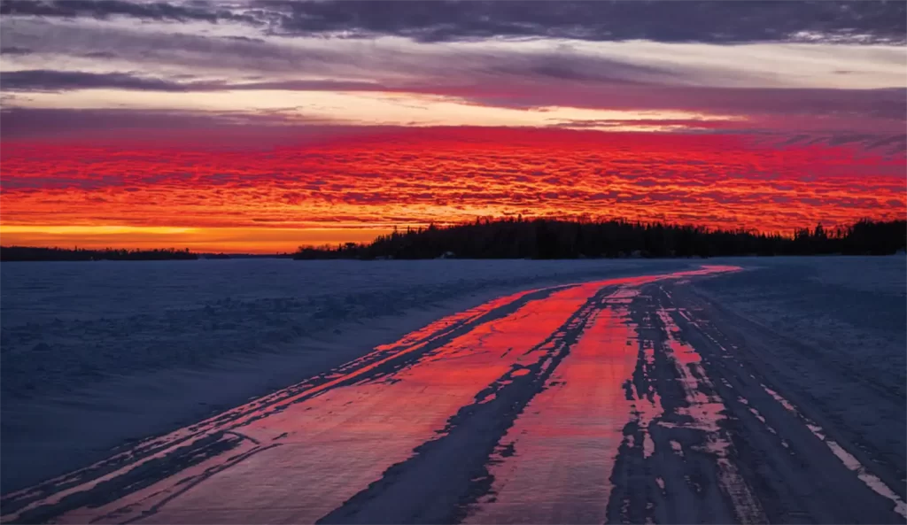 A view of an ice road at sunset.
