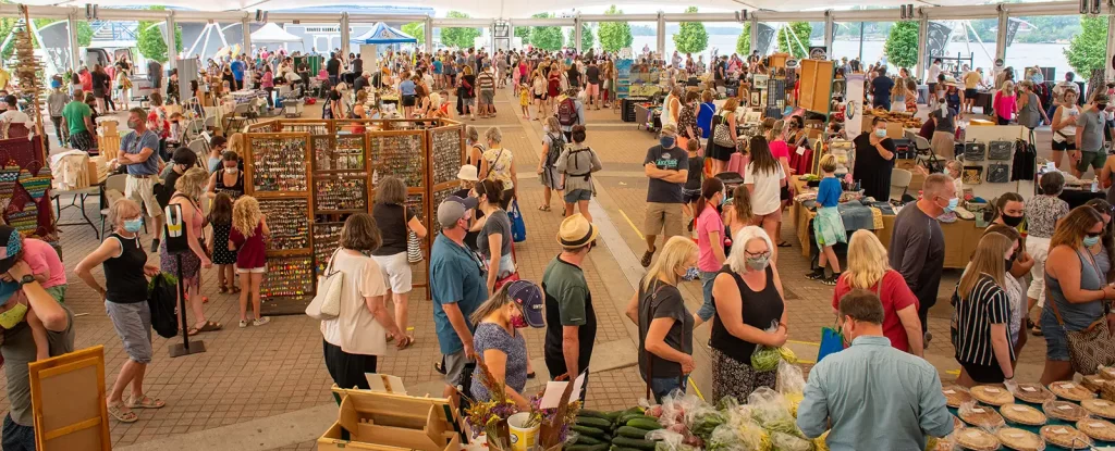 Hundreds of shoppers meander between stalls under the Whitecap Pavilion.